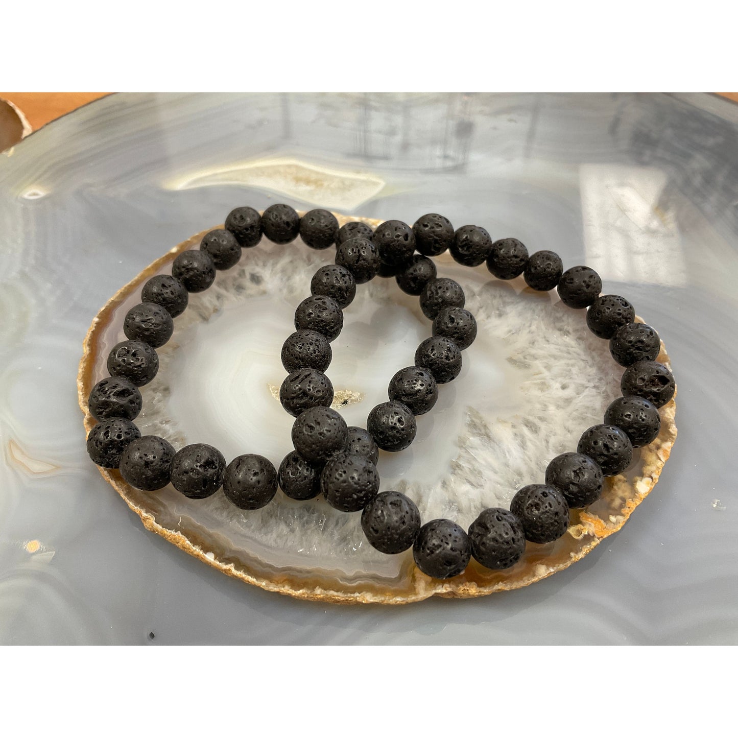 Lava stone bracelet side view, black matte porous volcanic bead essential oil diffuser